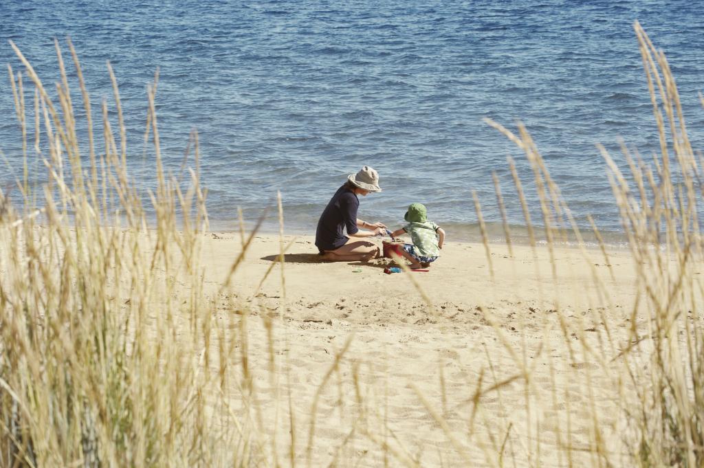 Mother and child playing on beach