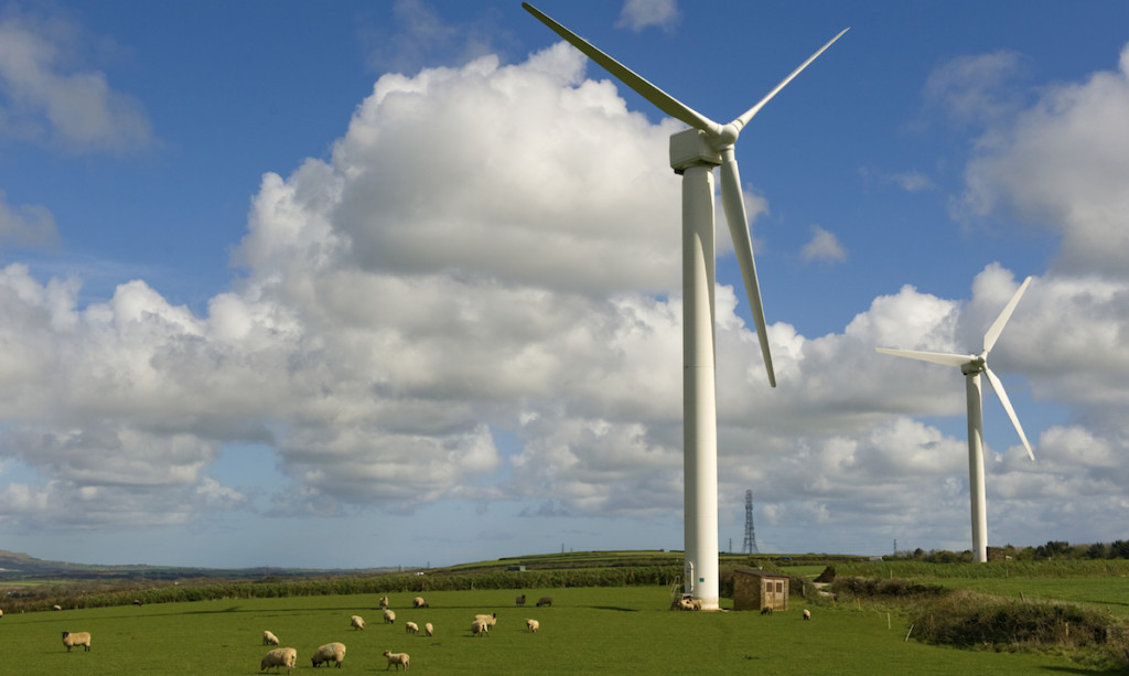 a photo of multiple wind turbines in an open field