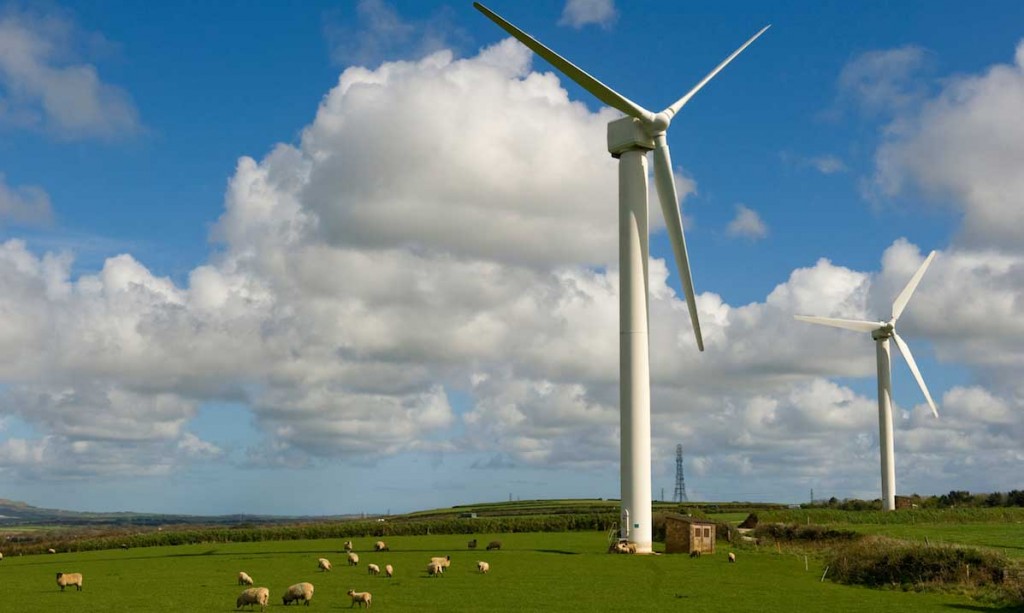 a photo of multiple wind turbines in an open field