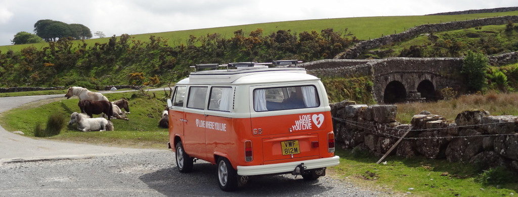 photo of a camper-van driving through the countryside