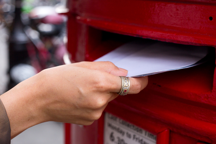 Posting a letter into the post box