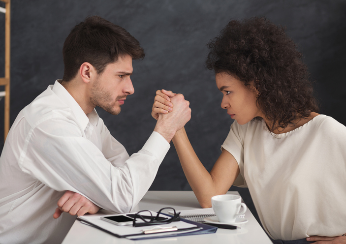 man and woman arm wrestling, concept for inheritance disputes