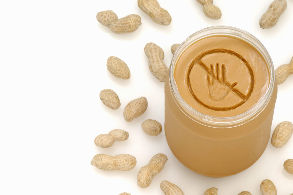 A concept photograph of a no entry or prohibited sign really engraved into a jar of peanut butter
