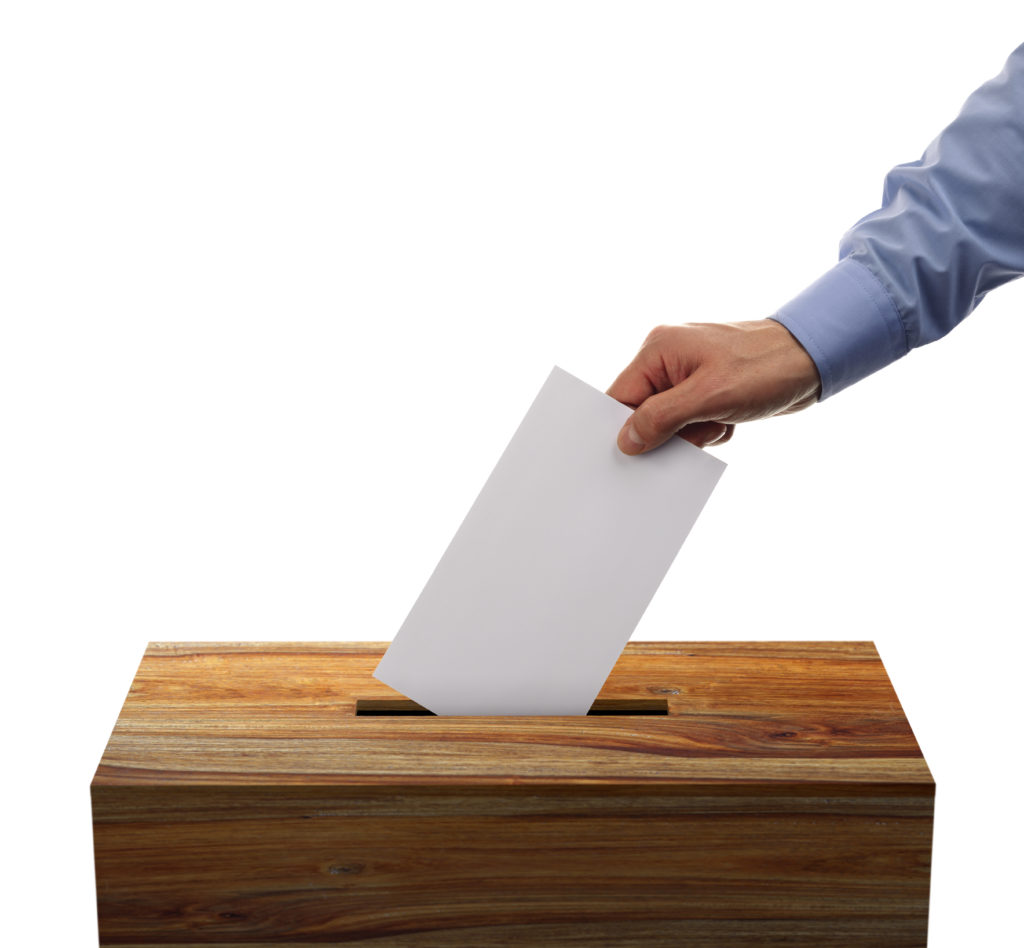 Ballot box with person casting vote on blank voting slip