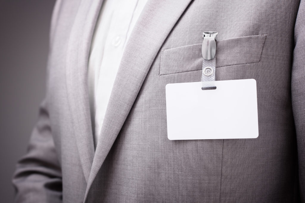 who to notify after name change - A close-up of a name tag on a jacket