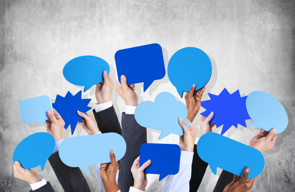 Business Arms Raised with Speech Bubble by Concrete Wall