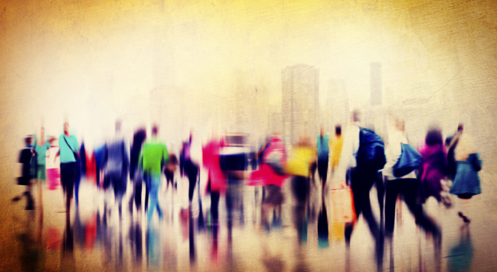 blurred photo of many people walking on a busy city street