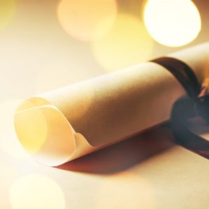 rolled up certificate tied up with a ribbon