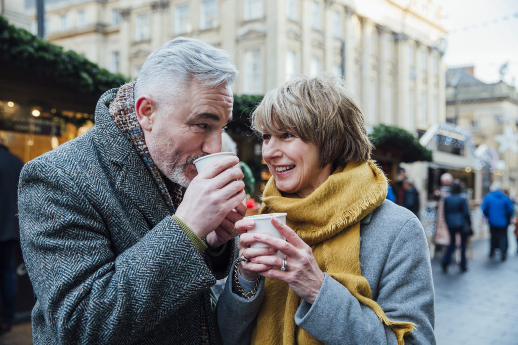 happy couple enjoying a coffee - concept: happy after agreeing a cohabitation agreement