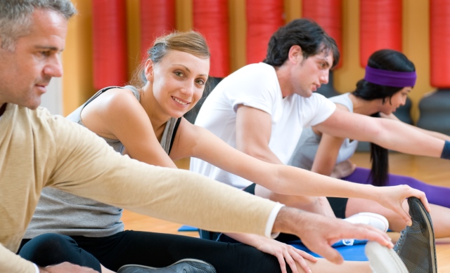 group of people exercising pilates