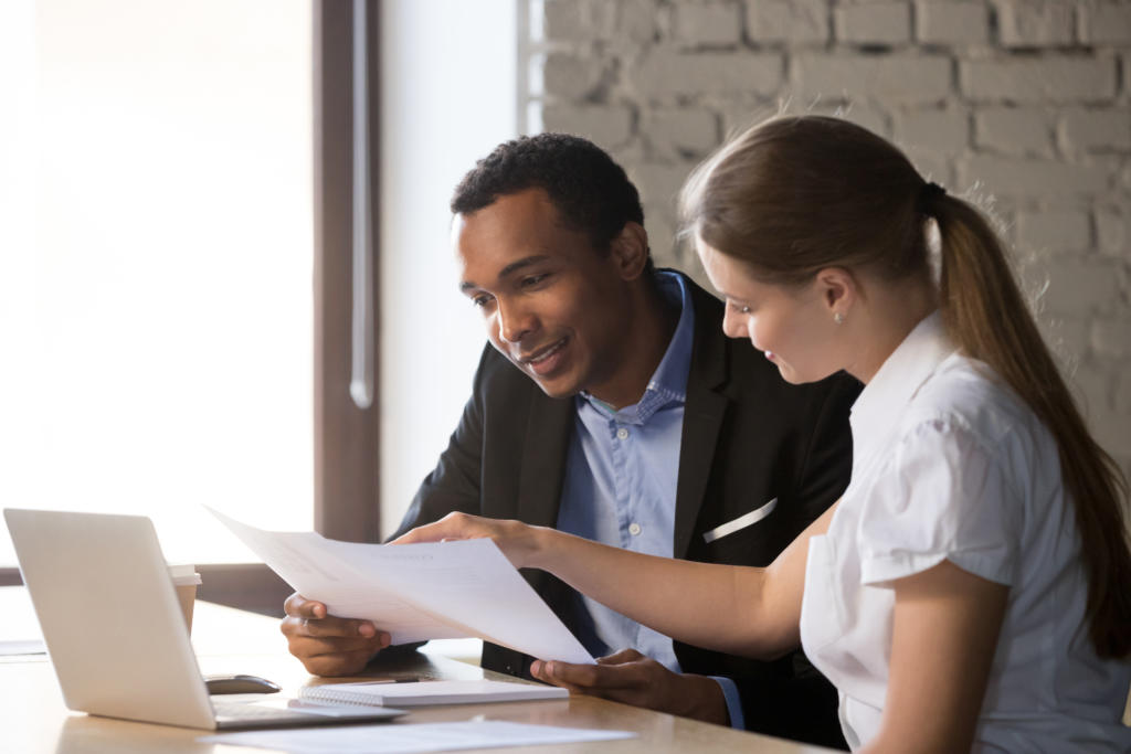 Woman giving male client financial advice