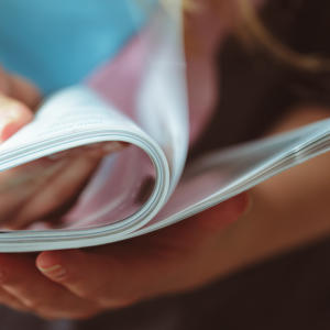 Woman flipping through magazine pages