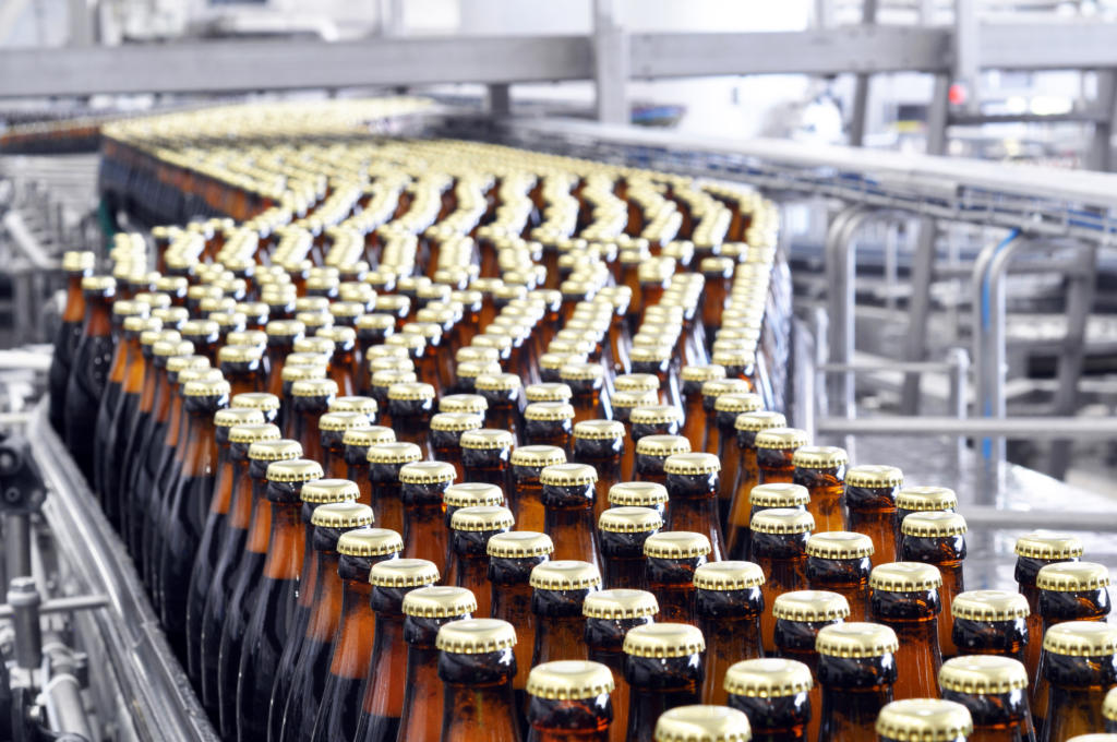 beer filling in a brewery - conveyor belt with glass bottles