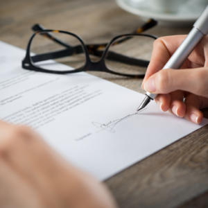 a hand signing employment contract