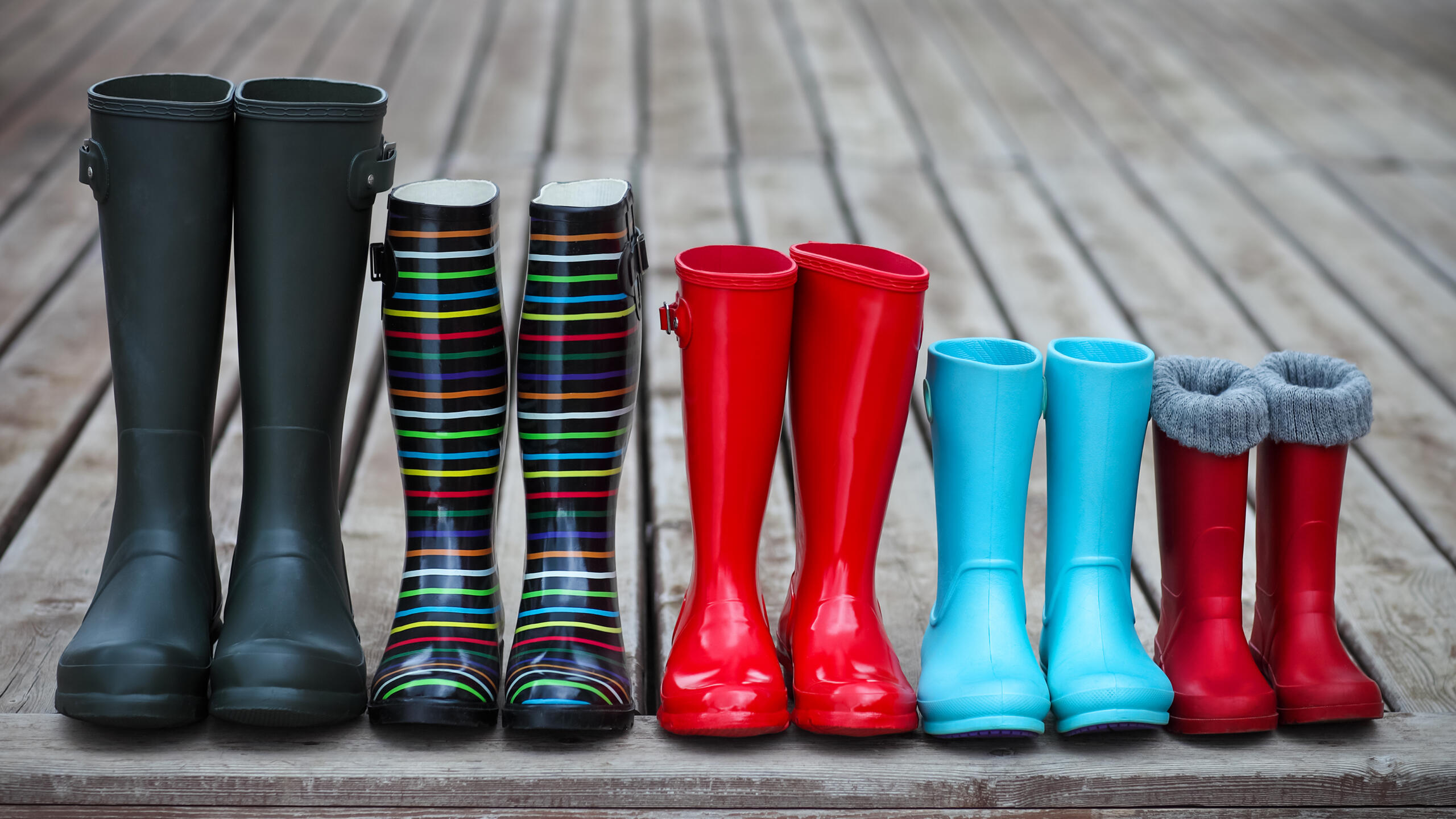 Photograph of five pairs of wellies of different sizes lined up together