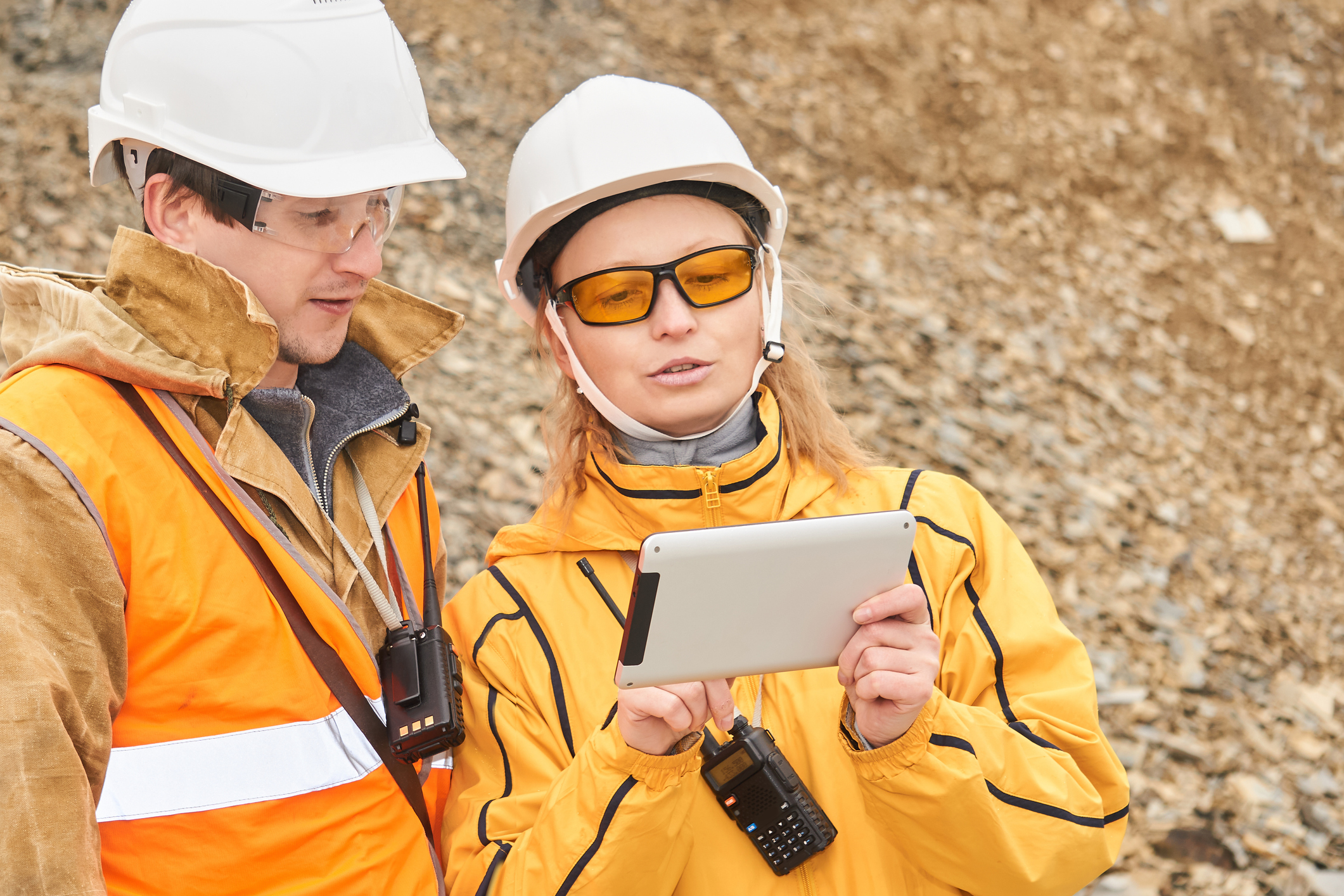 mining engineers discussing working documentation outdoor at the mining site