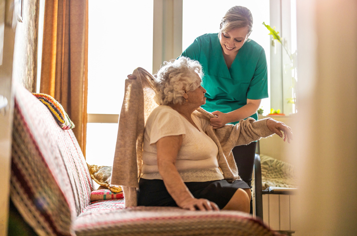 elderly person and carer in care home under cqc warning notice