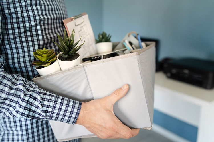 person collects box of belongings following lack of appeal in redundancy