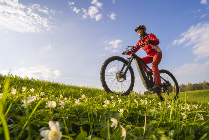 person on a bike in field of flowers saints way
