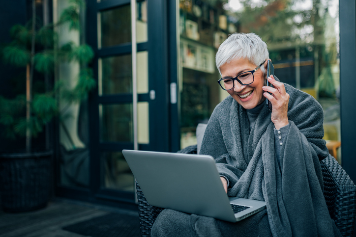 Smiling elder woman on a laptop, estate planning