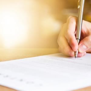 Hand with pen, signing a contract