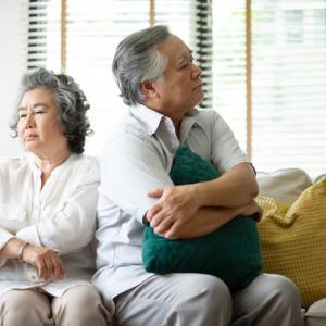 older couple facing away from each other. concept for disagreement over trusts as part of divorce