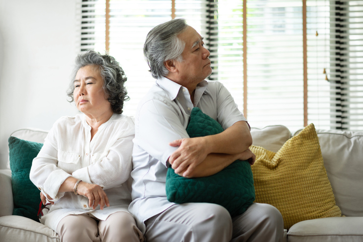 older couple facing away from each other. concept for disagreement over trusts as part of divorce