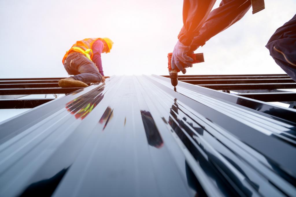 Roofers working on a construction project to ensure building safety