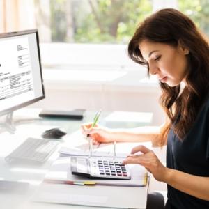 Accountant working out increases to national minimum wage and other employment payments
