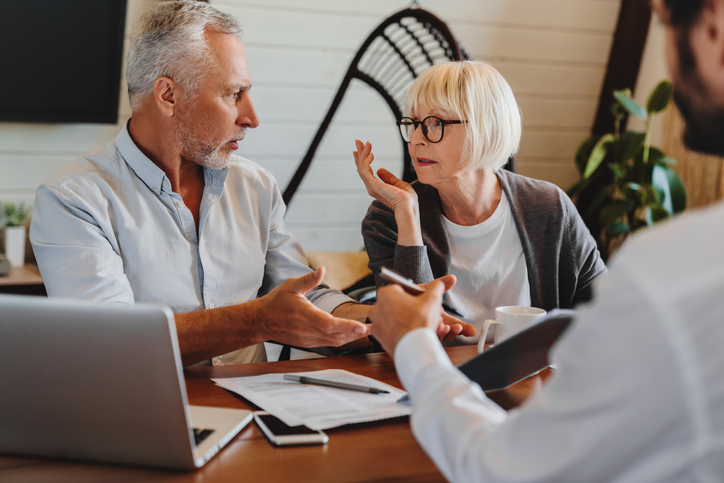 older divorced couple discussing maintenance variation with a lawyer