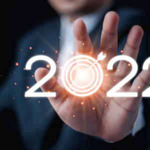 man in suit holding 2022, numbers in a tech light style - concept for data protection