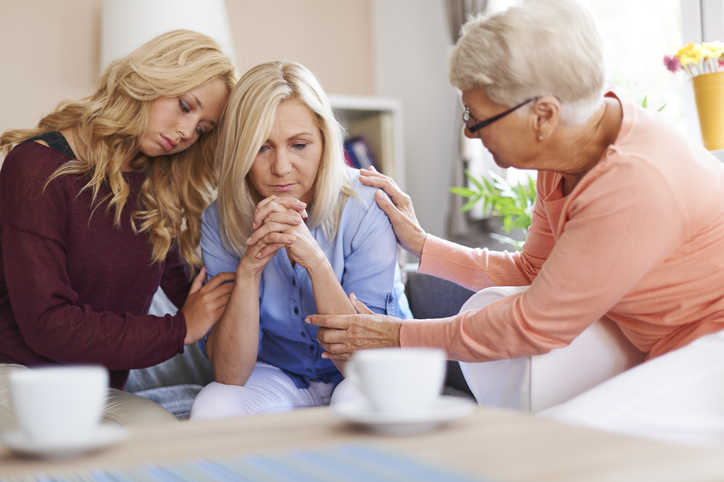 Three generations of women, comforting mother in the middle. Concept for deputies