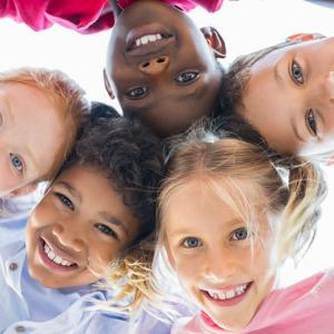 group of happy children looking at camera with heads together in circle. concept for children law