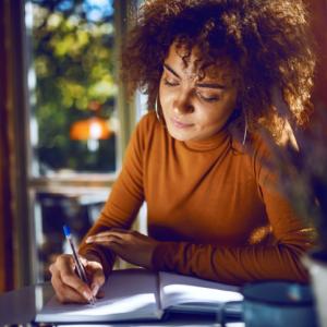 woman writing notes on how to build a purposeful business