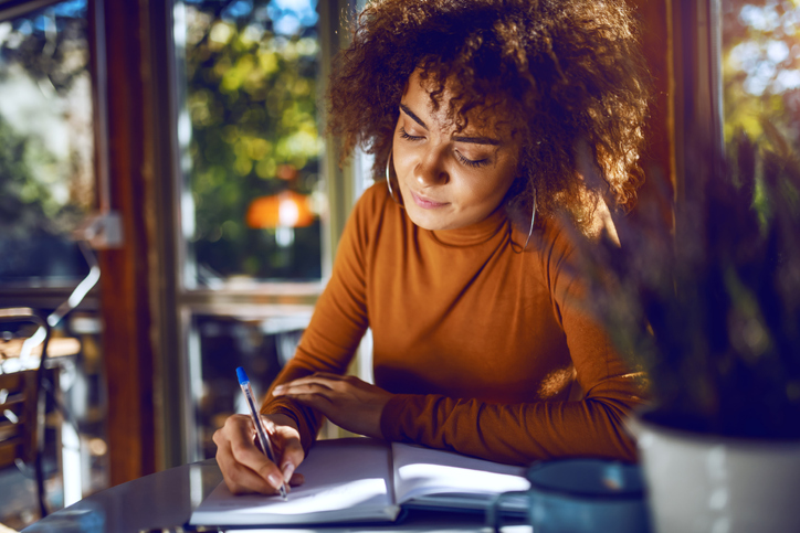 woman writing notes on how to build a purposeful business