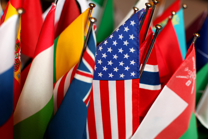 collection of world flags with US flag in focus. concept for US joining judgments convention