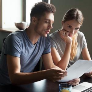 couple looking through paperwork. concept for reviewing pensions on divorce expert