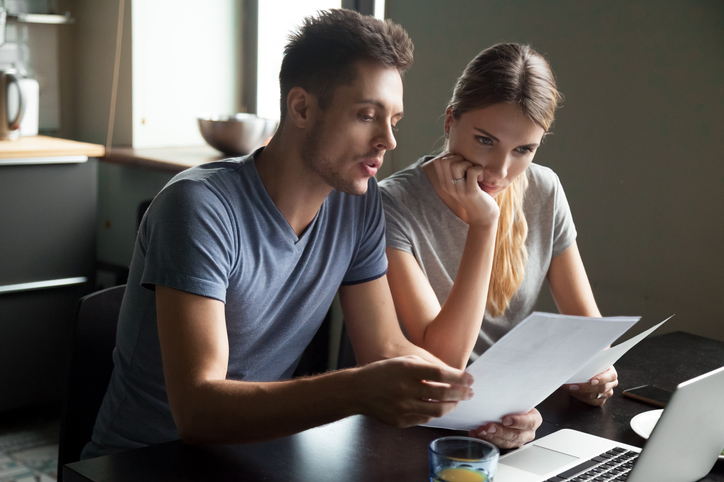 couple looking through paperwork. concept for reviewing pensions on divorce expert