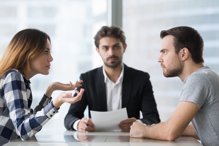 couple arguing in front of divorce lawyer. concept for disagreement over cost orders