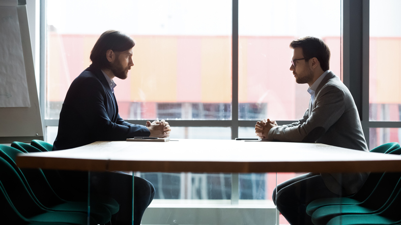 two men having business meeting. concept for discussing professional negligence