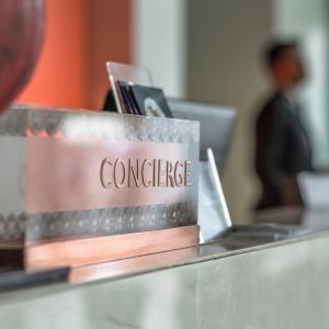 a concierge plaque on a hotel reception desk