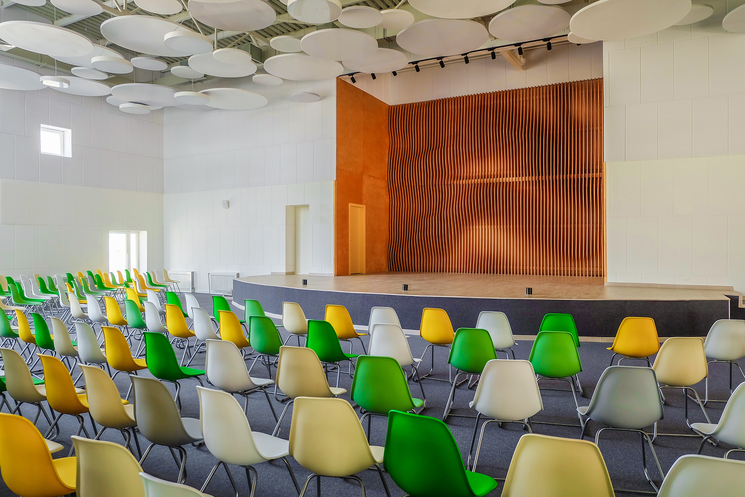 School assembly hall with stage for performance and rows of seats