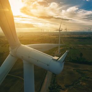 a photo of multiple wind turbines in an open area