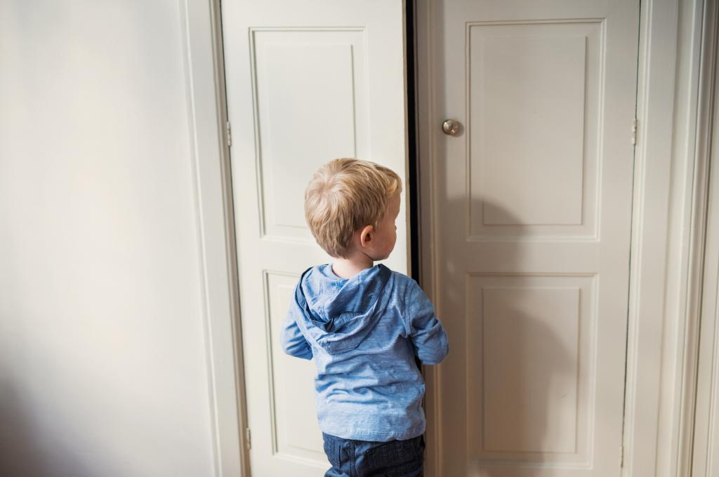 boy standing in front of door