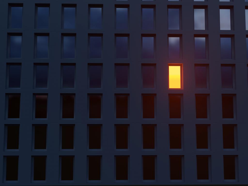 front shot of a large building with only one unit lighted