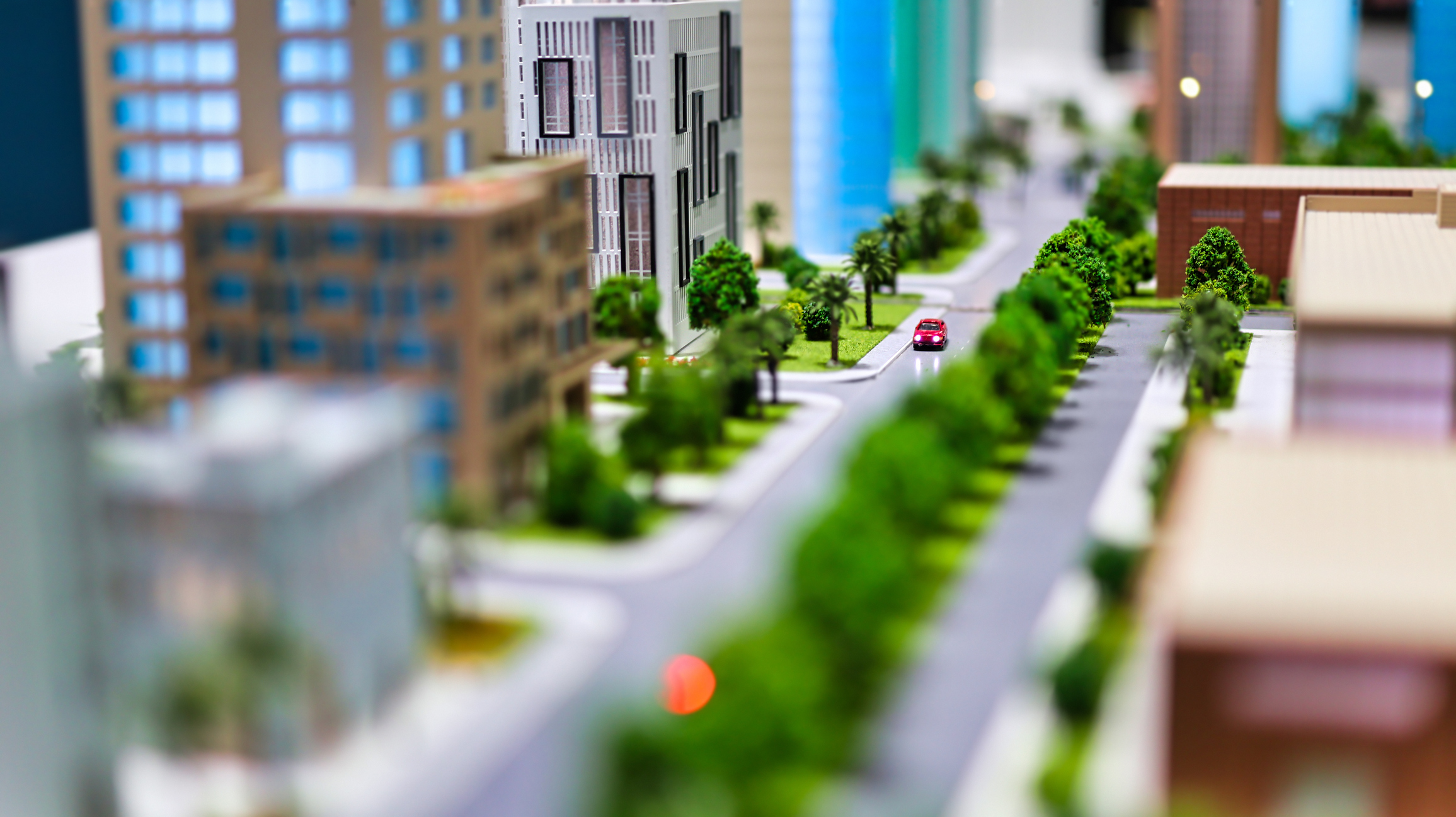 a model of a street with buildings and cars