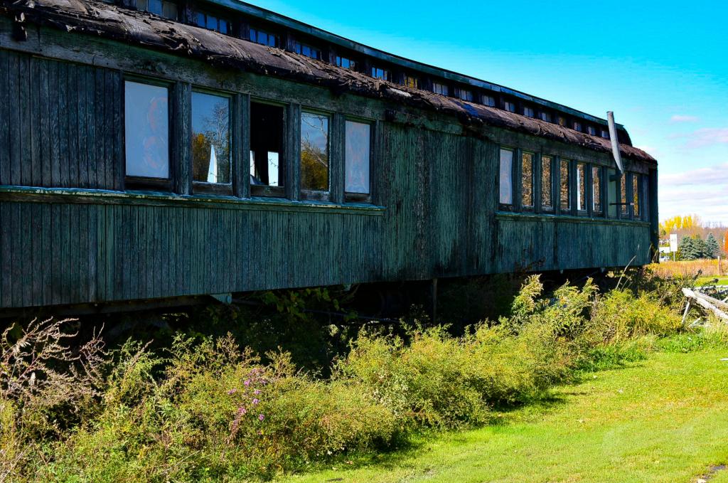An old abandoned railway carriage in a field