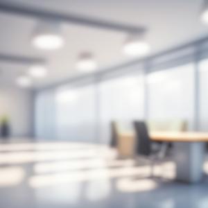 Blurred photograph of a light modern office interior with panoramic windows and beautiful lighting.