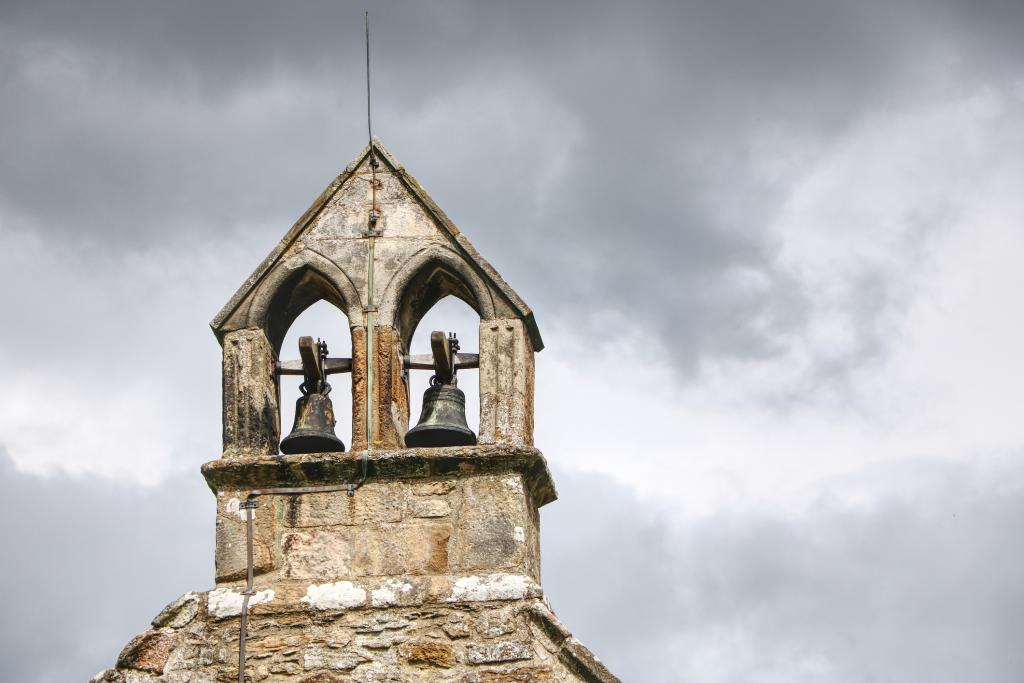 Old church bell tower with a grey sky in the background