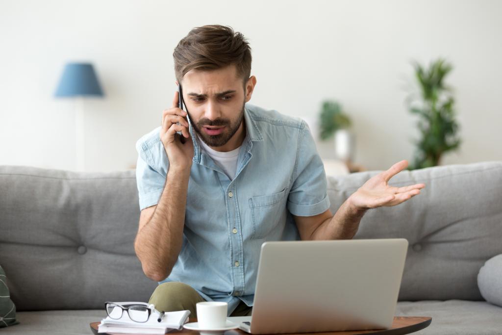 Frustrated man talking on phone trying to get a response